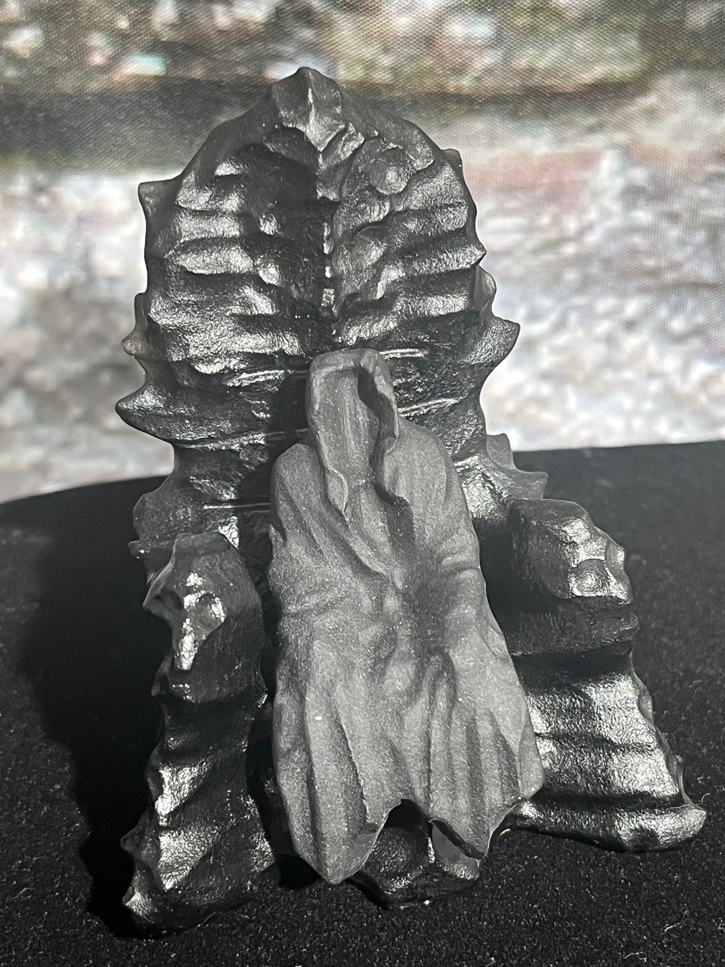 Grim reaper sitting on throne stone/crystal carving